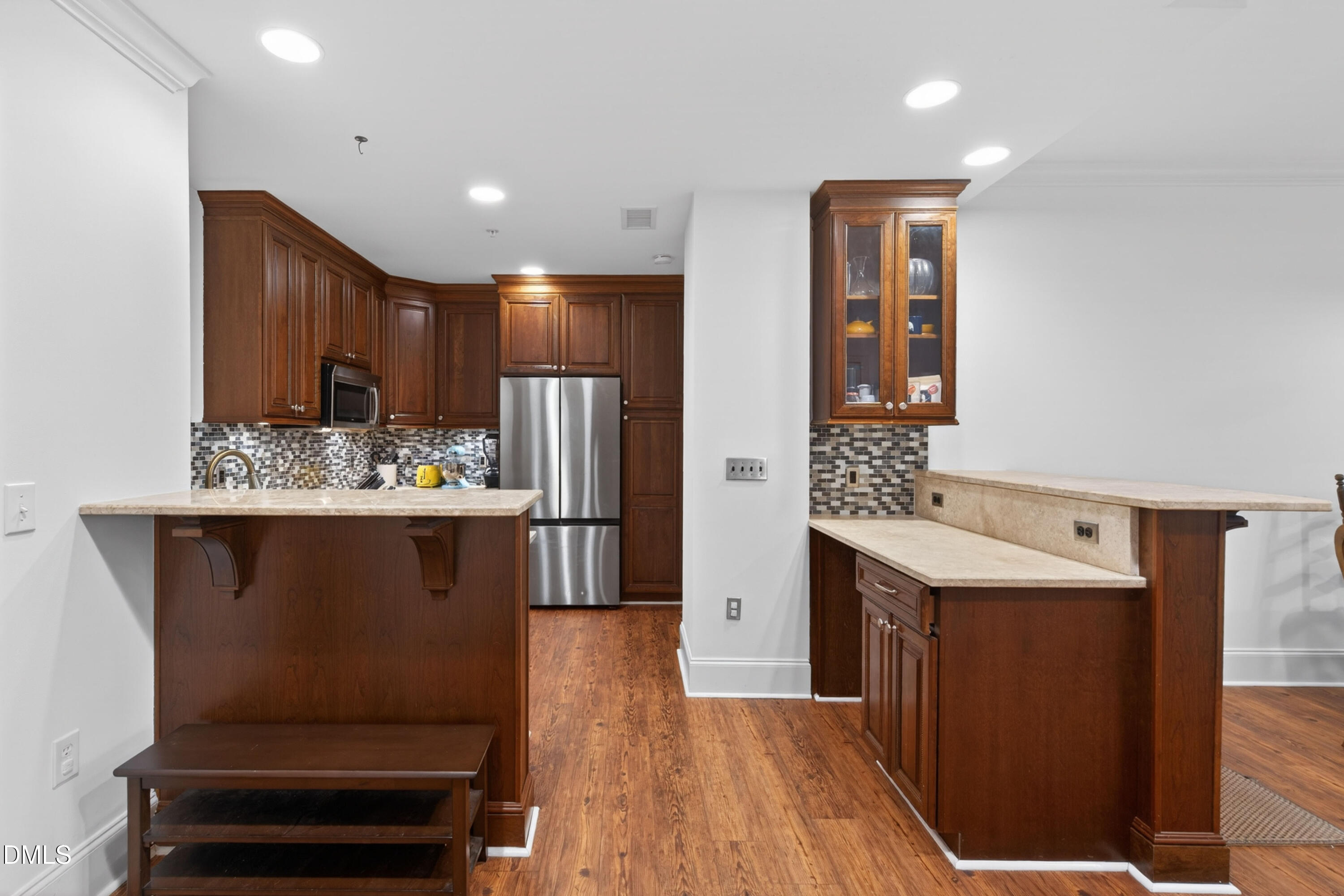 710 Independence Place, Unit 104 Raleigh, NC 27603 - Photo 7 of 34 a kitchen with kitchen island cabinets and refrigerator