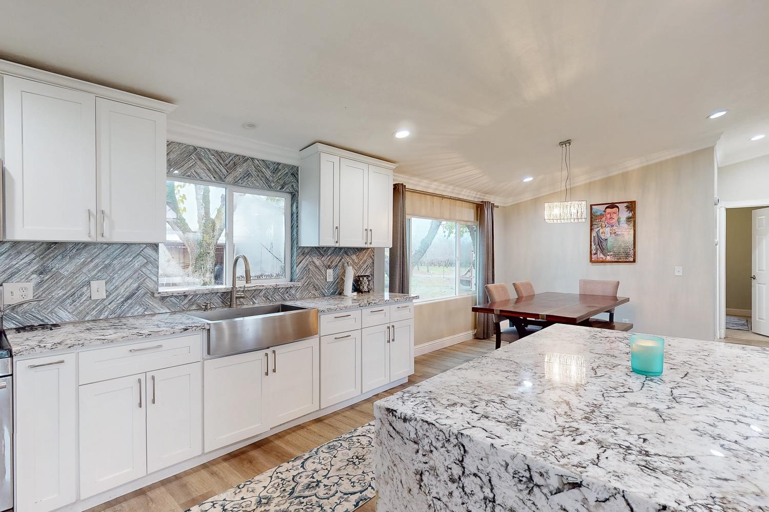 3453 La Porte Road Marysville, CA 95901 - Photo 21 of 81 a large white kitchen with granite countertop a sink white cabinets and granite counter tops