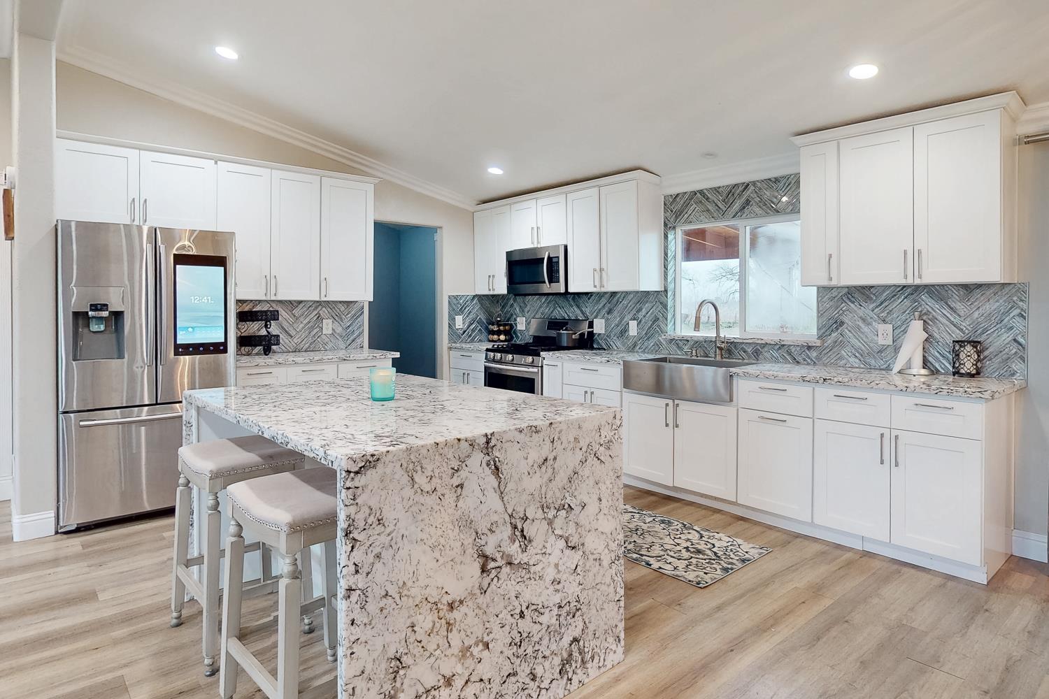 3453 La Porte Road Marysville, CA 95901 - Photo 9 of 81 a kitchen with stainless steel appliances granite countertop a sink stove refrigerator and cabinets