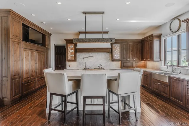 a kitchen with stainless steel appliances a stove a sink and cabinets