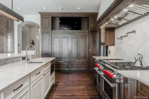 a kitchen with stainless steel appliances kitchen island granite countertop a stove and cabinets