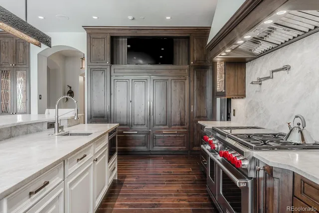 a kitchen with stainless steel appliances kitchen island granite countertop a stove and cabinets