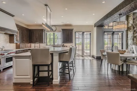 a dining room with kitchen island stainless steel appliances furniture a dining table and chairs