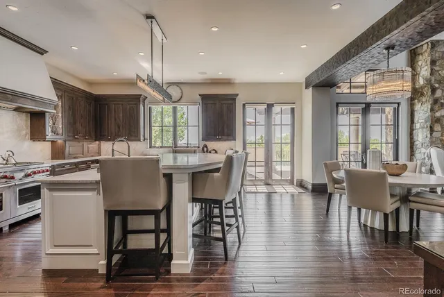 a dining room with kitchen island stainless steel appliances furniture a dining table and chairs
