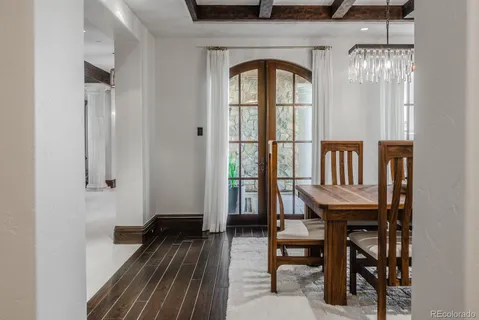 a spacious bedroom with a bed couch and windows