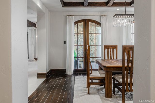 a spacious bedroom with a bed couch and windows