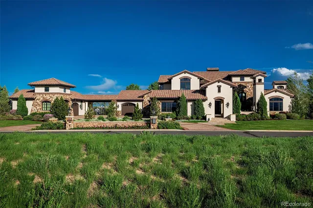 a front view of a house with a yard table and chairs
