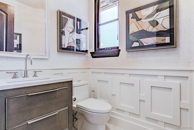 a living room with furniture a large window and a chandelier