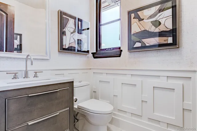 a living room with furniture a large window and a chandelier
