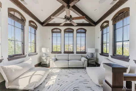 a spacious bedroom with a bed and a flat screen tv