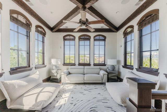 a spacious bedroom with a bed and a flat screen tv
