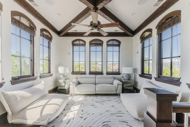 a spacious bedroom with a bed and a flat screen tv