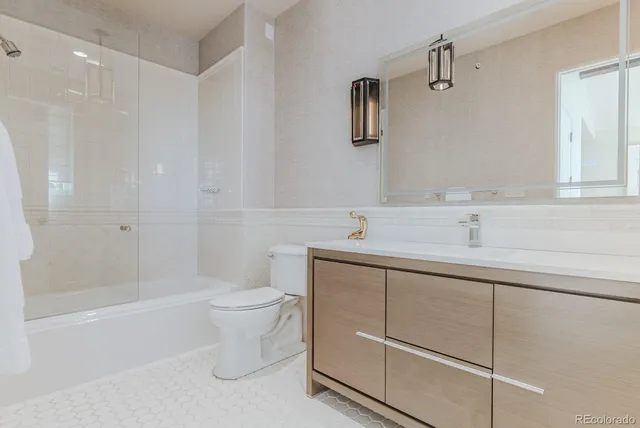 a spacious bedroom with a bed and a large window