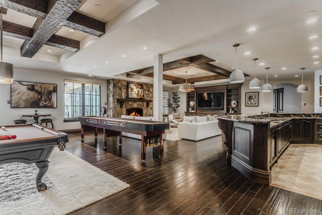 a open kitchen with stainless steel appliances granite countertop a stove and a sink