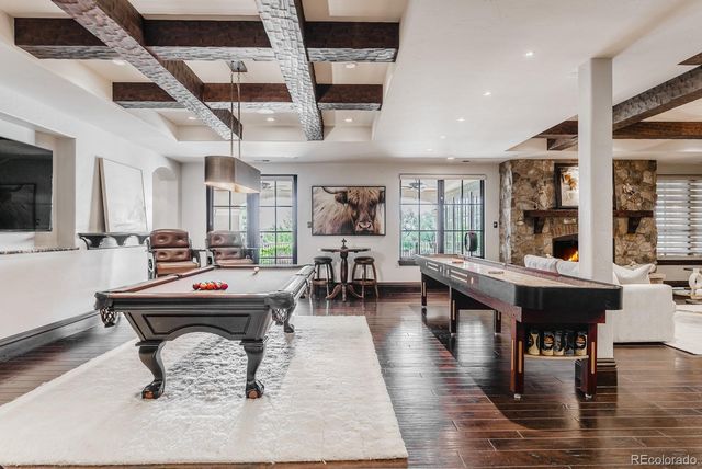 a living room with furniture a fireplace and a large window