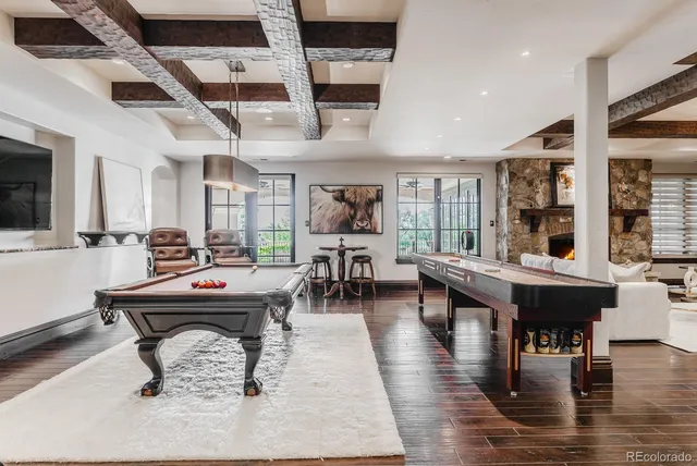 a living room with furniture a fireplace and a large window