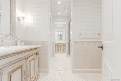 a spacious bedroom with a bed and a flat screen tv