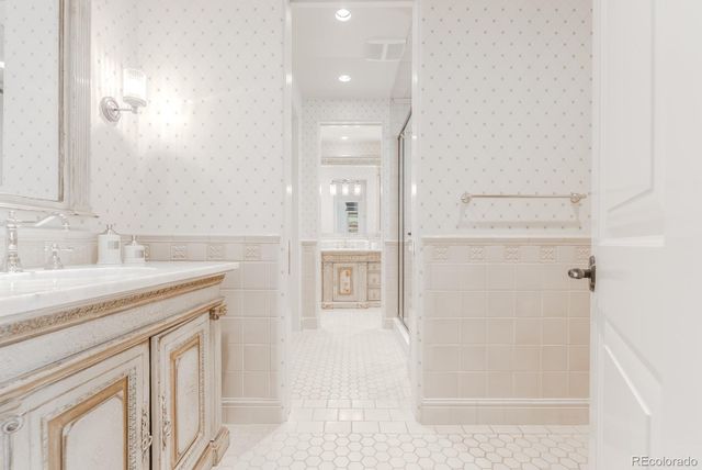 a spacious bedroom with a bed and a flat screen tv