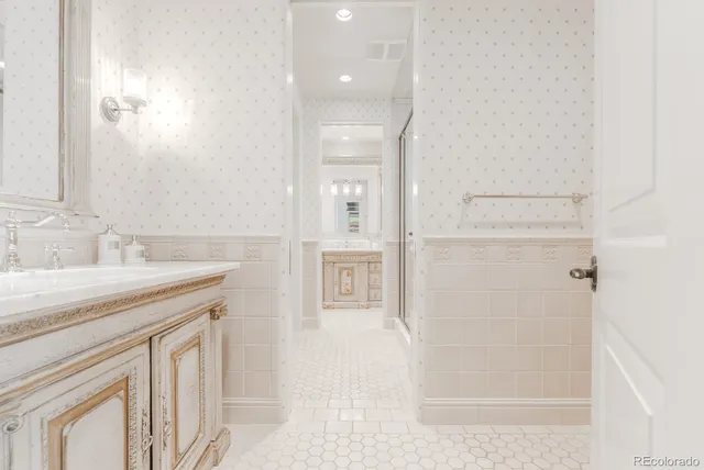 a spacious bedroom with a bed and a flat screen tv