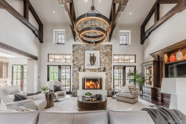 a living room with furniture a fireplace and a large window