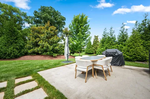 a white bench sitting in a grassy field