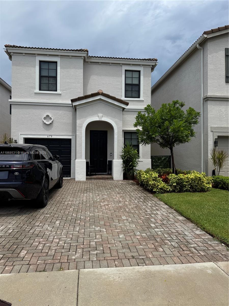 a front view of a house with a garden