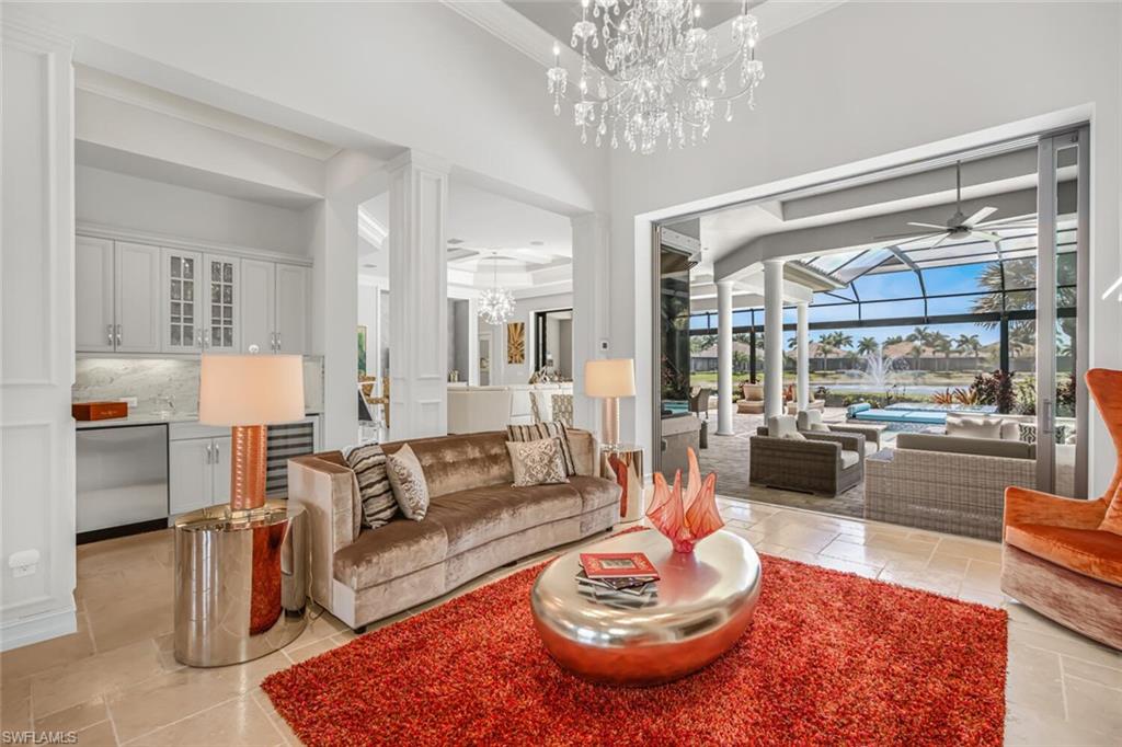 6624 Barbera Lane Naples, FL 34113 - Photo 11 of 50 a living room with furniture and a chandelier