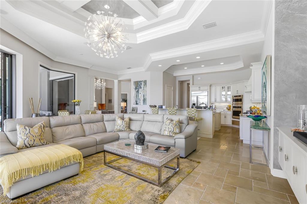 6624 Barbera Lane Naples, FL 34113 - Photo 13 of 50 a living room with furniture and a chandelier