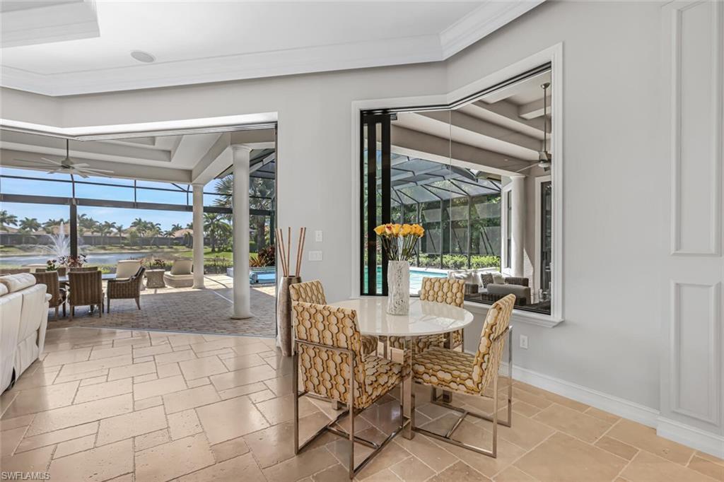 6624 Barbera Lane Naples, FL 34113 - Photo 15 of 50 a dining room with furniture and large windows