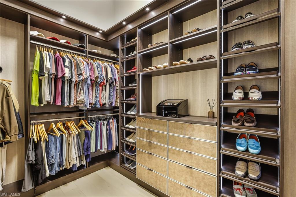 6624 Barbera Lane Naples, FL 34113 - Photo 20 of 50 a view of walk in closet with clothes and shoes