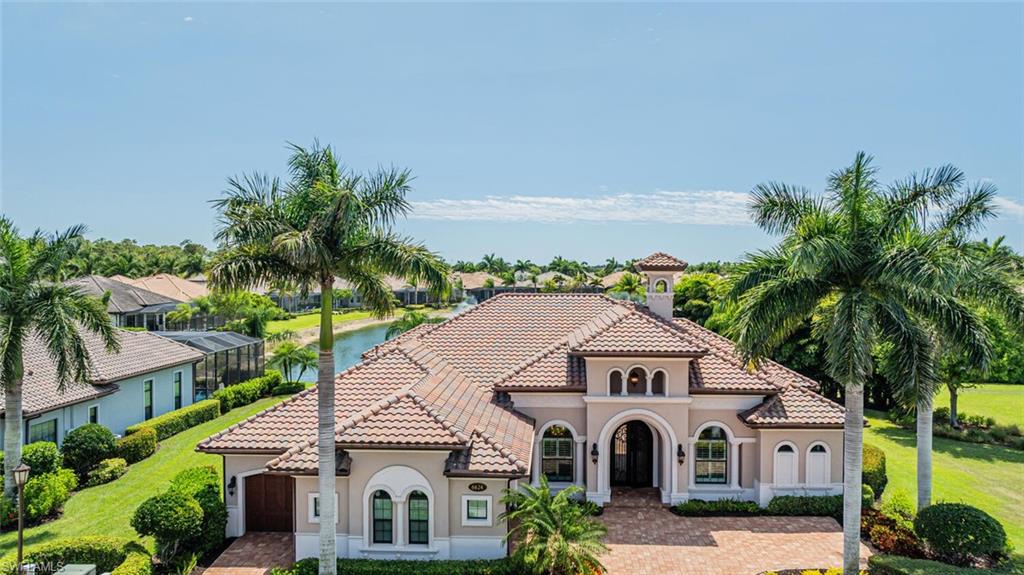 6624 Barbera Lane Naples, FL 34113 - Photo 2 of 50 a front view of a house with a yard