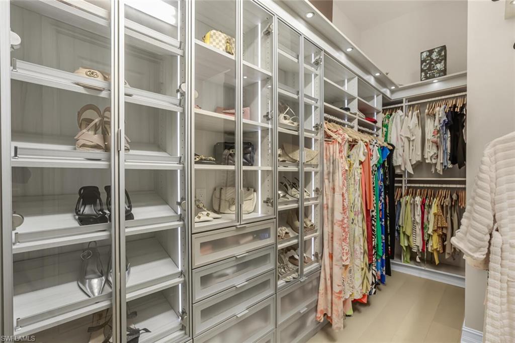 6624 Barbera Lane Naples, FL 34113 - Photo 21 of 50 a view of walk in closet with clothes and shoes