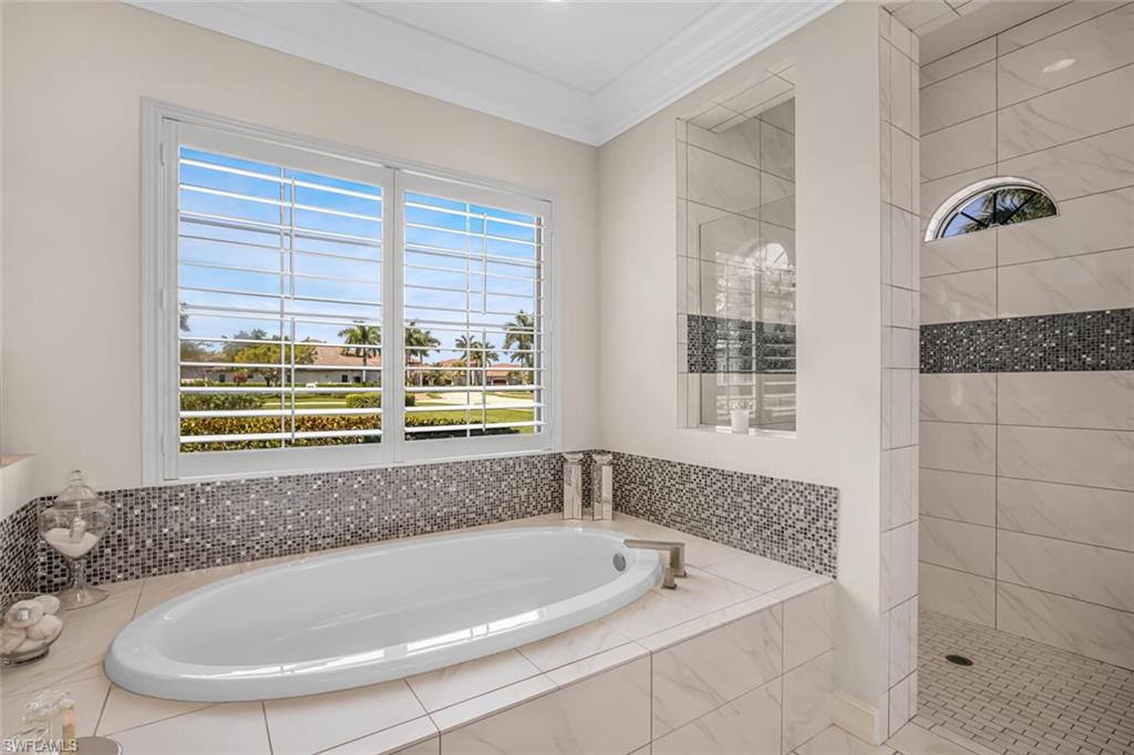 6624 Barbera Lane Naples, FL 34113 - Photo 24 of 50 a bath tub sitting in a bathroom next to a window