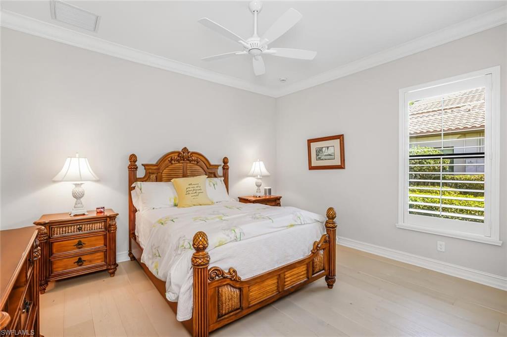 6624 Barbera Lane Naples, FL 34113 - Photo 25 of 50 a bedroom with a bed and a lamp on the dresser