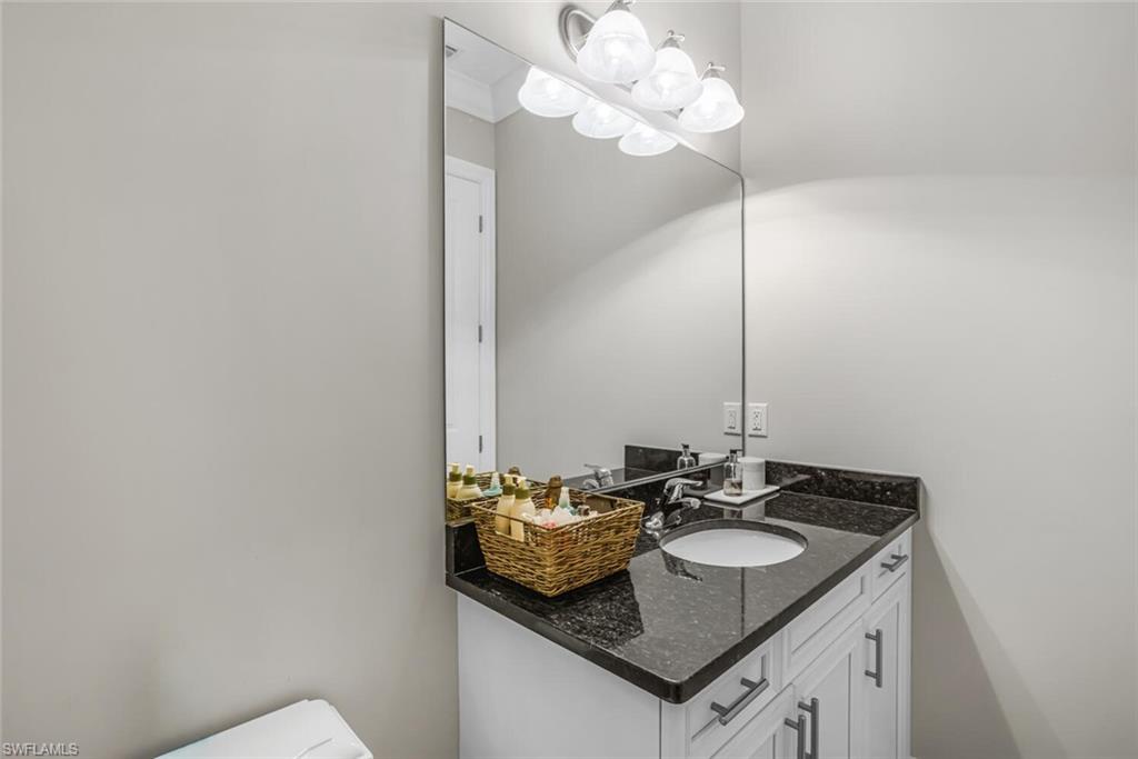 6624 Barbera Lane Naples, FL 34113 - Photo 28 of 50 a bathroom with a sink and a mirror