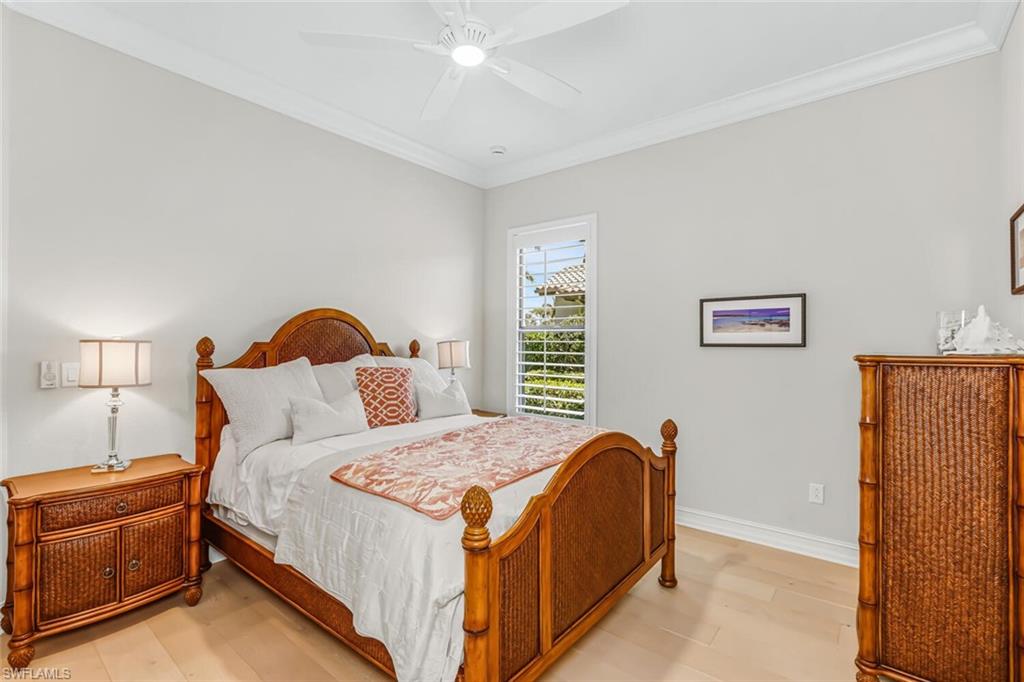 6624 Barbera Lane Naples, FL 34113 - Photo 29 of 50 a bedroom with a bed and a lamp