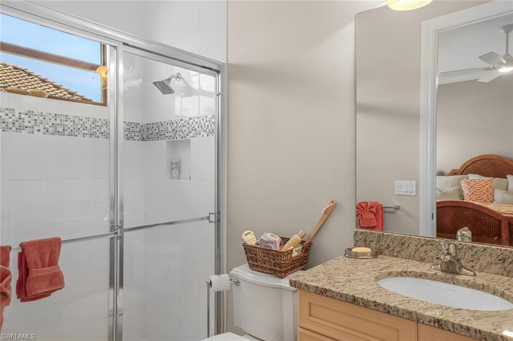 6624 Barbera Lane Naples, FL 34113 - Photo 30 of 50 a bathroom with a granite countertop sink and a mirror