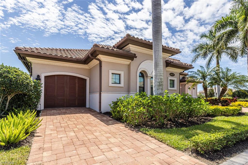 6624 Barbera Lane Naples, FL 34113 - Photo 3 of 50 a front view of a house with a garden