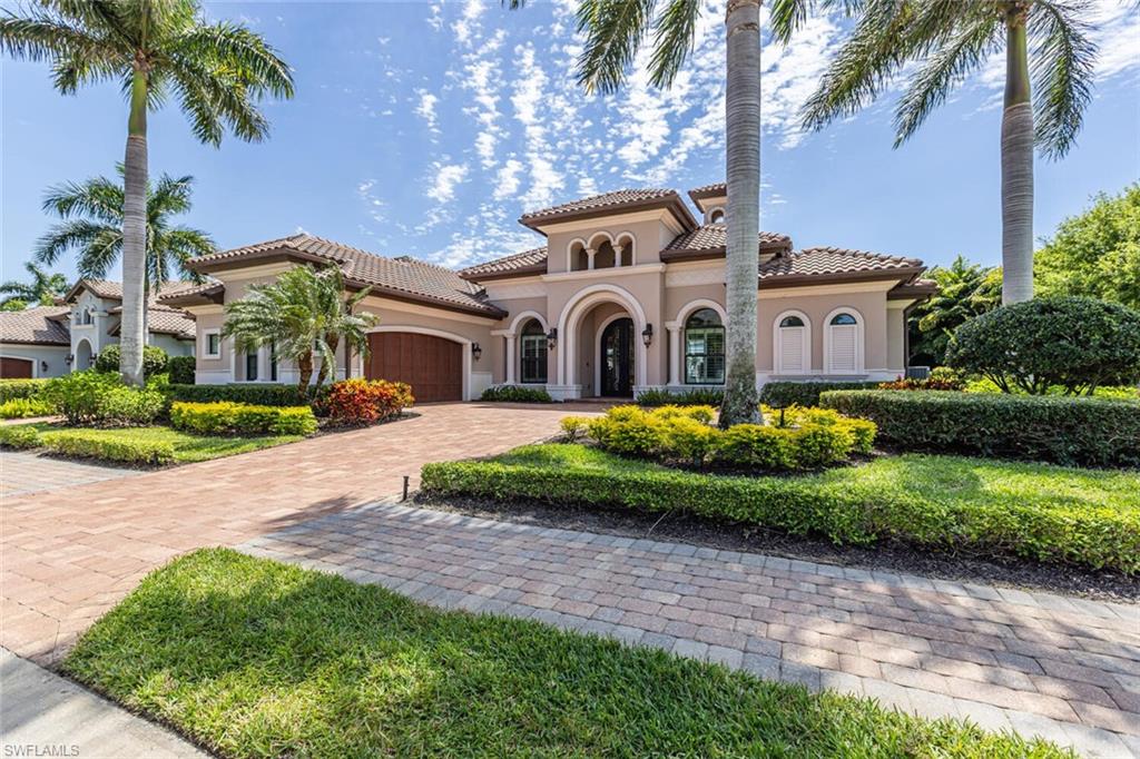 6624 Barbera Lane Naples, FL 34113 - Photo 4 of 50 a front view of a house with a garden and trees