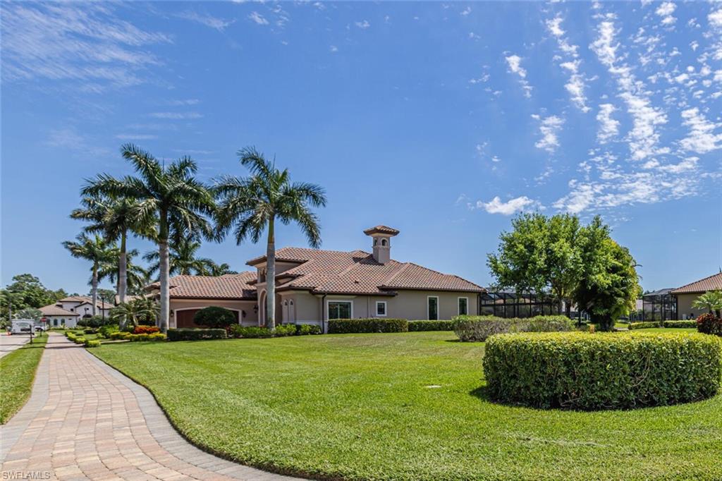 6624 Barbera Lane Naples, FL 34113 - Photo 45 of 50 a front view of a house with a garden
