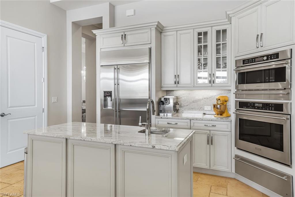6624 Barbera Lane Naples, FL 34113 - Photo 6 of 50 a kitchen with stainless steel appliances granite countertop a sink stove and refrigerator