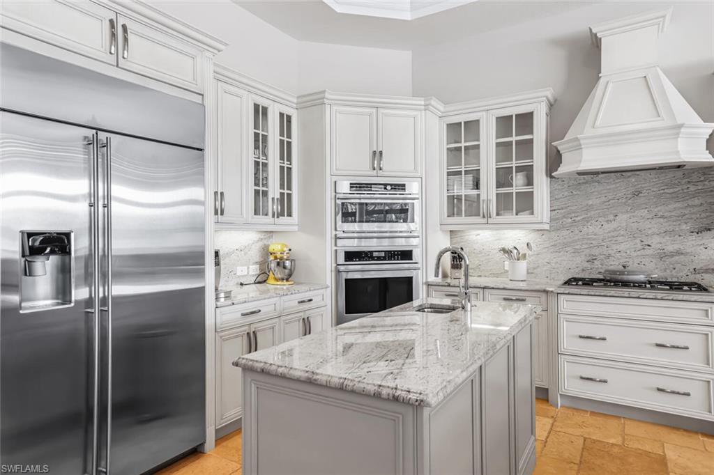 6624 Barbera Lane Naples, FL 34113 - Photo 7 of 50 a kitchen with a refrigerator and a sink
