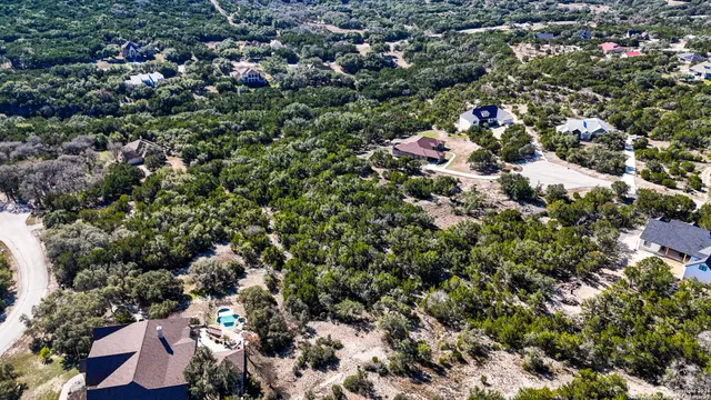 an aerial view of a houses with a yard