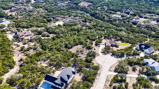 an aerial view of a house with a yard and outdoor seating