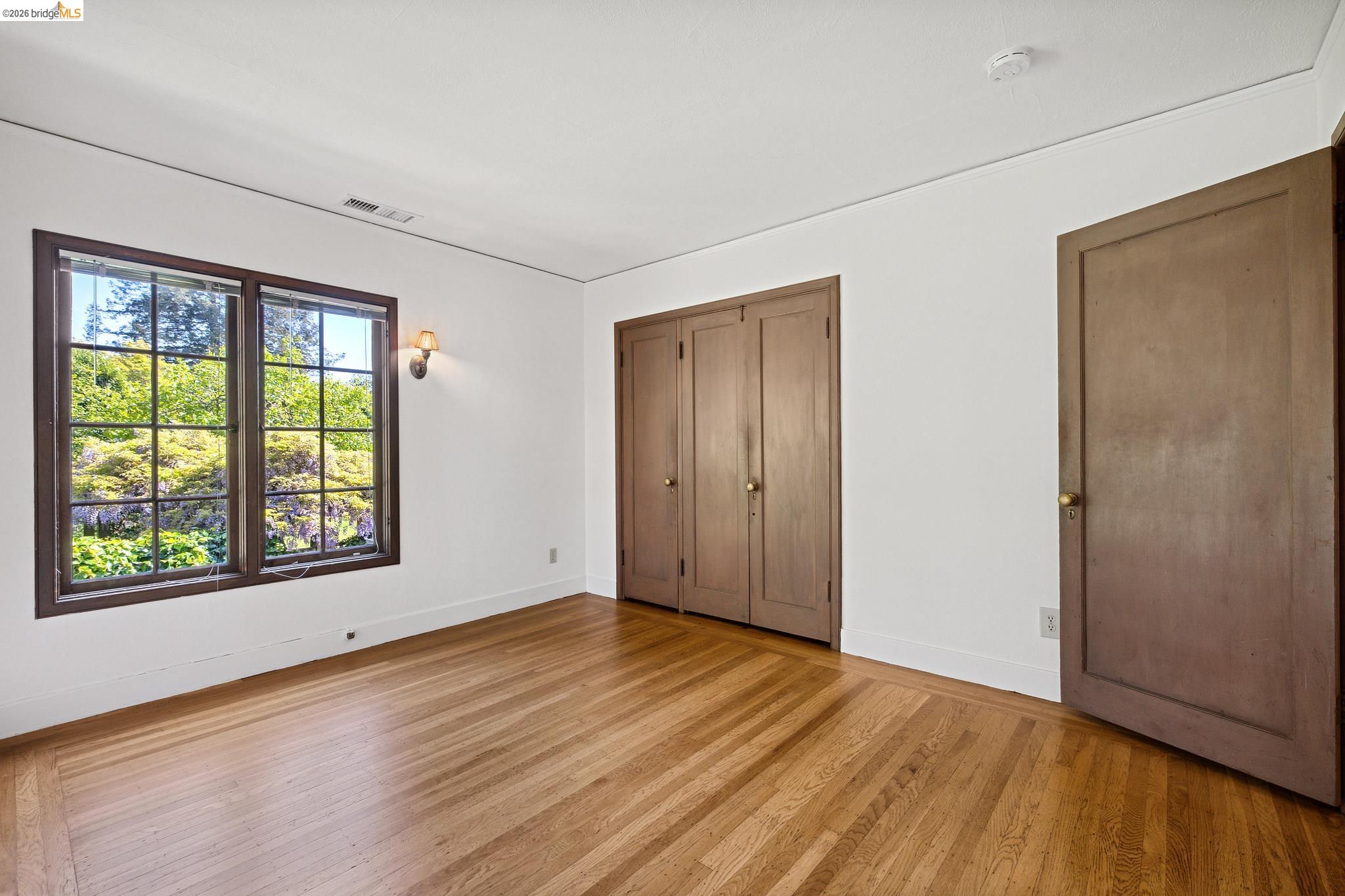 2501 Rose Walk Berkeley, CA 94708 - Photo 56 of 60 a view of an empty room with wooden floor and a window
