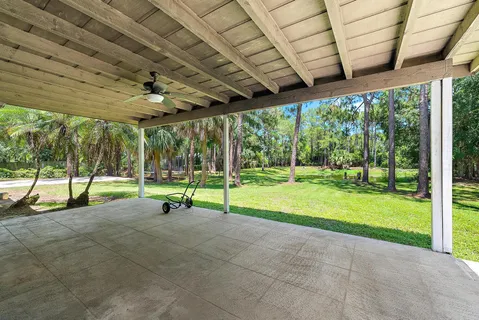 a view of a backyard with porch and garden