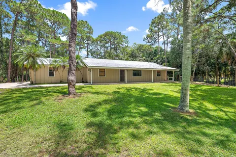 a house view with swimming pool and garden