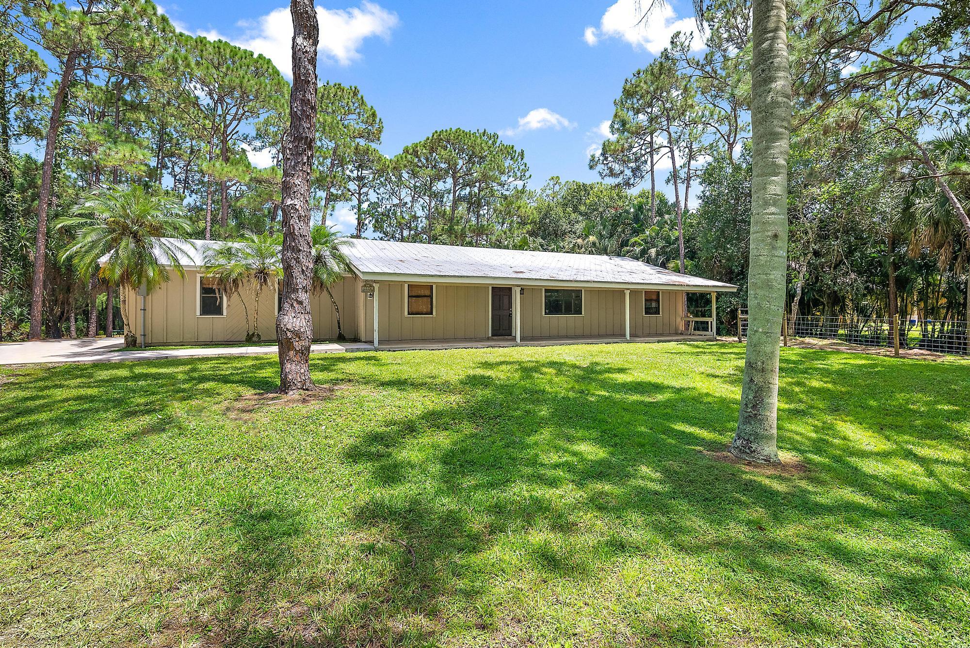 18222 126th Terrace North Jupiter, FL 33478 - Photo 2 of 22 a house view with swimming pool and garden