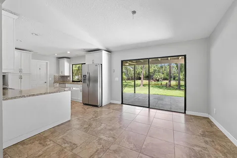 a view of a kitchen with a sink and refrigerator