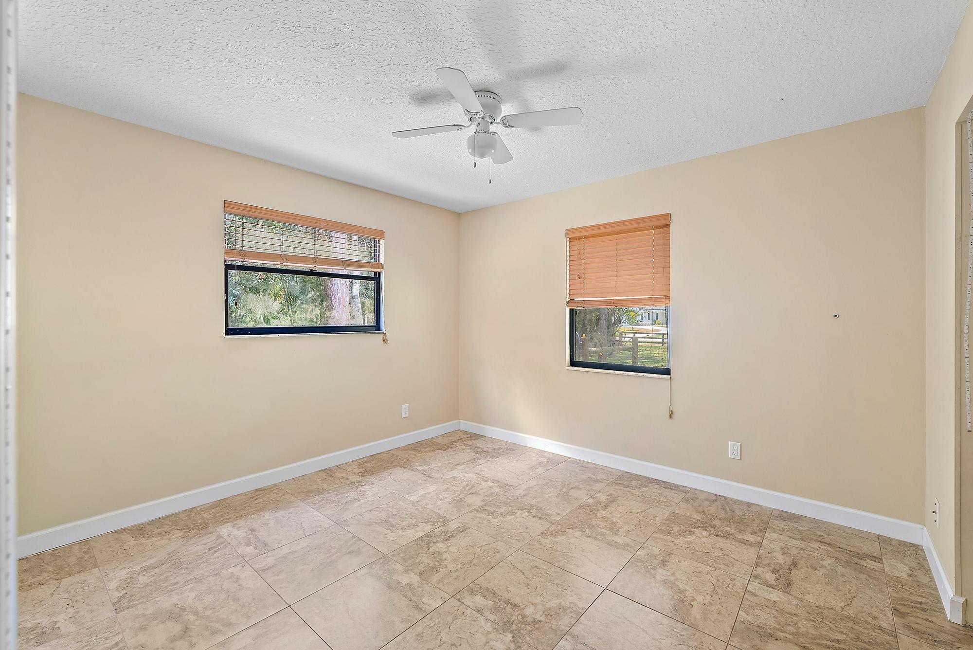 18222 126th Terrace North Jupiter, FL 33478 - Photo 9 of 22 a view of a big room with wooden floor and windows